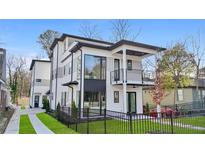 Modern two-story home boasting sleek black trim, large windows, a balcony, and a well-manicured front yard with black fence at 1137 Hardee Ne St # B, Atlanta, GA 30307