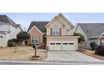 Charming two-story home with a two-car garage, a brick facade, and neutral siding in a well-kept neighborhood at 2025 Drogheda Ln, Marietta, GA 30066