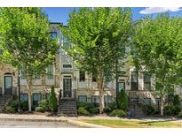 Charming townhome with brick facade, green trees, and a welcoming front entrance at 709 Bismark Ne Rd, Atlanta, GA 30324