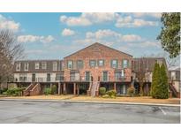 Charming brick townhouse with individual balconies and well-maintained landscaping, creating a welcoming curb appeal at 3091 Colonial Way # D4, Atlanta, GA 30341