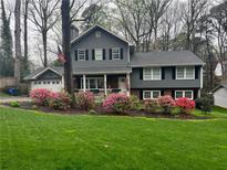 Charming two-story home with a well-manicured lawn and beautiful blooming bushes at 1938 Gotham Ne Way, Atlanta, GA 30324