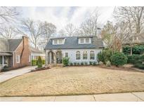 Charming home with stone archway, dormer windows and a manicured lawn at 1195 Cameron Ne Ct, Atlanta, GA 30306