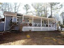Charming ranch home with a covered porch and a well-maintained front yard at 7240 Colony Ln, Douglasville, GA 30135