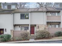 Charming townhouse with brick accents and cozy front porch, nestled in a tranquil community at 1205 Druid Knoll Ne Dr, Brookhaven, GA 30319