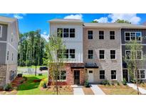 Beautiful townhome with a mix of brick and siding and a well-manicured lawn at 5463 Blossomwood Sw Trl, Mableton, GA 30126