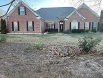 Charming brick home featuring black shutters and a well-maintained lawn at 1507 Smithfield Dr, Mcdonough, GA 30252