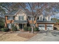 Charming two-story home with a well-manicured lawn and a two-car garage at 4323 Lake Chimney Ne Ct, Roswell, GA 30075