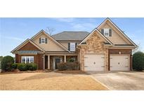 Charming two-story home featuring a stone facade, brick accents, and an attached two-car garage at 108 Long Leaf Way, Canton, GA 30114