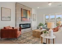 Inviting living room featuring a modern fireplace, stylish decor, and comfortable seating at 1903 Deco Dr, Kennesaw, GA 30144