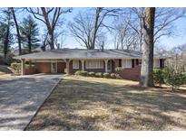 Charming brick home with a covered front porch and well-maintained landscaping at 5468 Melanie Sw Ln, Mableton, GA 30126