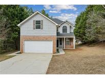 Charming two-story home with a two-car garage, brick accents, and a well-maintained front yard at 2704 River Summit Ln, Decatur, GA 30034