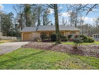 Charming ranch-style home with attached garage and mature landscaping in a quiet neighborhood at 921 Forest Park Ln, Suwanee, GA 30024