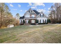 Charming two-story home with a landscaped yard and a combination of siding and brick exterior at 2778 Macland Rd, Dallas, GA 30157