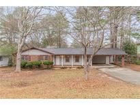 Charming single-story home featuring a covered carport and inviting front porch at 50 Carriage Trce, Stockbridge, GA 30281