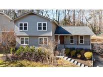 Charming two-story home with a gray facade, complemented by a well-manicured front yard at 3044 Windfield Cir, Tucker, GA 30084