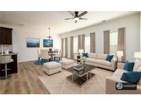 Bright living room featuring neutral tones, modern decor, and dining area with stylish furnishings at 4940 Elm Brook Dr, Atlanta, GA 30349