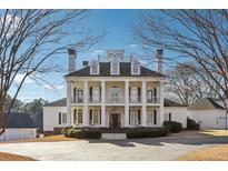 Stately colonial home with grand entrance featuring white columns and symmetrical design at 2595 Ross Rd, Snellville, GA 30039