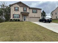 Charming two-story home featuring brick facade, and a well-manicured lawn at 738 Basswood Ave, Mcdonough, GA 30252