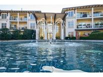 Condominium complex featuring a water fountain and landscaped entry with an attractive courtyard and building features at 3101 Howell Mill Nw Rd # 327, Atlanta, GA 30327