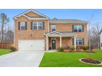 Inviting two-story brick home with a well-manicured lawn and attached two-car garage at 2713 Serena Way, South Fulton, GA 30331
