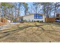 Charming single-story home featuring a white brick facade, large windows, and a well-maintained lawn at 3180 Vine Cir, Decatur, GA 30033