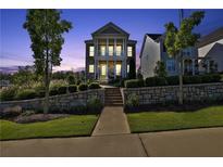 Charming two-story home featuring stone accents, a cozy porch, and professionally landscaped front yard at 545 Hanlon Way, Alpharetta, GA 30009