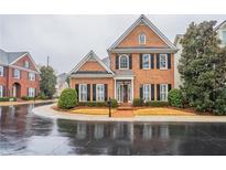 Charming two-story brick home features manicured landscaping, black shutters, and a welcoming front entrance at 1521 Reids Ferry Way, Marietta, GA 30062