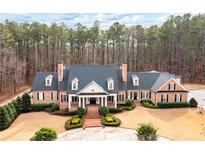 Stately brick home with a classic design, surrounded by lush greenery and mature trees at 3201 Hobsons Ridge Nw Trl, Acworth, GA 30101