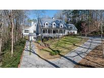 Charming two-story home with a welcoming front porch and beautifully landscaped front yard at 4000 Conway Valley Nw Rd, Atlanta, GA 30327