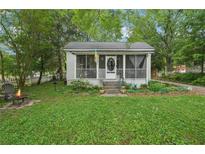 Charming home featuring a screened porch, small fire pit and lush greenery at 1610 Elm Ne St, Conyers, GA 30012