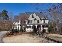 Charming two-story home with a welcoming front porch and well-manicured landscaping at 3150 Dartmouth Pl, Cumming, GA 30041
