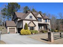 Beautiful two story home featuring brick and siding accents, manicured front yard and two-car garage at 3740 Tupelo Trl, Auburn, GA 30011
