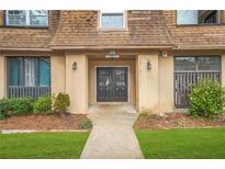 Condominium exterior featuring a well-maintained landscape, a peaked roof, and inviting entrance at 3100 Parc Lorraine, Lithonia, GA 30038