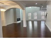 Spacious living room features wood floors, fireplace and an open floor plan with lots of natural light at 868 Still Hill Ln, Lawrenceville, GA 30045