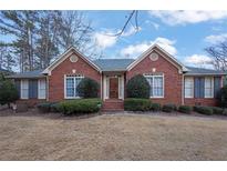 Charming one-story brick home with blue shutters and a well-manicured front lawn at 9272 Fairgreen Ct, Jonesboro, GA 30236