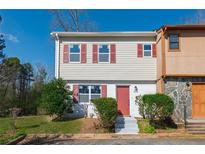 Charming two-story townhouse with light siding and red shutters, nestled in a suburban community at 2102 Lenoa Ln, Austell, GA 30106