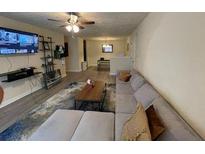 Cozy living room features a sectional sofa, mounted TV, and stylish decor at 5301 Fairington Club Dr, Lithonia, GA 30038