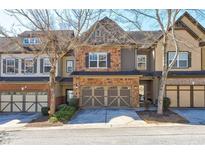 Charming townhouse with a two-car garage and beautiful stone and brick accents, offering curb appeal at 2613 Stonekey Bnd, Lithonia, GA 30058