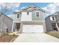 Charming two-story home with a brick-accented facade and a spacious two-car garage at 2778 Aralynn Way, College Park, GA 30337