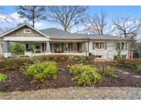 Charming single story home with gray painted brick and well-maintained landscaping and inviting front porch at 2262 Ridgedale Ne Rd, Atlanta, GA 30317