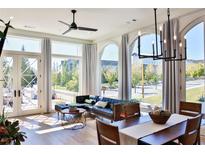 Bright living room featuring large windows, hardwood floors, and stylish modern furnishings at 100 5Th St, Fayetteville, GA 30214