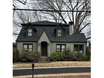 Charming two-story home featuring a gray roof, dormers, and a well-maintained front yard at 1549 Beecher Sw St, Atlanta, GA 30310