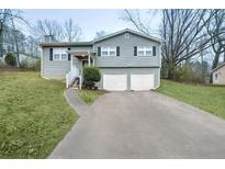 Charming two-story home with gray siding, black shutters, and an attached two-car garage at 3990 N Quail Dr, Douglasville, GA 30135