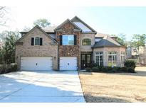 Charming two-story home with brick and stone facade and attached two-car garage at 1365 Willis Lake Dr, Kennesaw, GA 30152