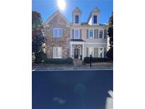 Charming two-story home featuring a stone facade and dormer windows under a clear blue sky at 1580 Reids Ferry Way, Marietta, GA 30062