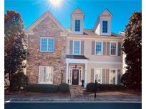 Charming two-story home featuring a stone facade and dormer windows, plus a welcoming front porch at 1580 Reids Ferry Way, Marietta, GA 30062