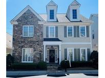 Charming two-story home featuring stone accents, gray shutters, and manicured landscaping at 1580 Reids Ferry Way, Marietta, GA 30062