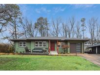 Charming ranch home with a beautifully manicured lawn, modern garage door, and inviting front porch at 1322 Elmhurst Circle Se Cir, Atlanta, GA 30316