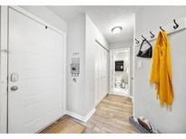 Inviting entryway with light-colored wood flooring, coat hooks, and access to the bathroom at 3655 Habersham Ne Rd # B129, Atlanta, GA 30305