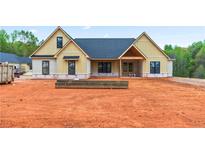 Newly constructed home featuring board and batten siding and a covered front porch at 628 Sandhill Hickory Level Rd, Carrollton, GA 30116